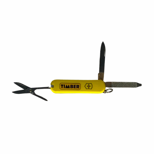 Canivete amarelo com ferramentas abertas, incluindo uma tesoura, uma lâmina pequena e uma lixa. Exibe o logotipo "TIMBER" e um símbolo da Suíça em destaque.